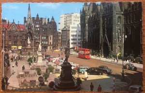 View of Albert Square showing a double decker bus outside the Town Hall before the stones were cleaned