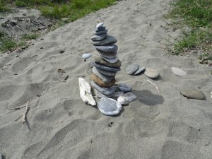A cairn of rounded pebbles on a sandy path