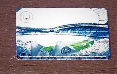 The back of Tony's Manchester City football club season card showing the crowded stadium and a sunlit pitch. 
