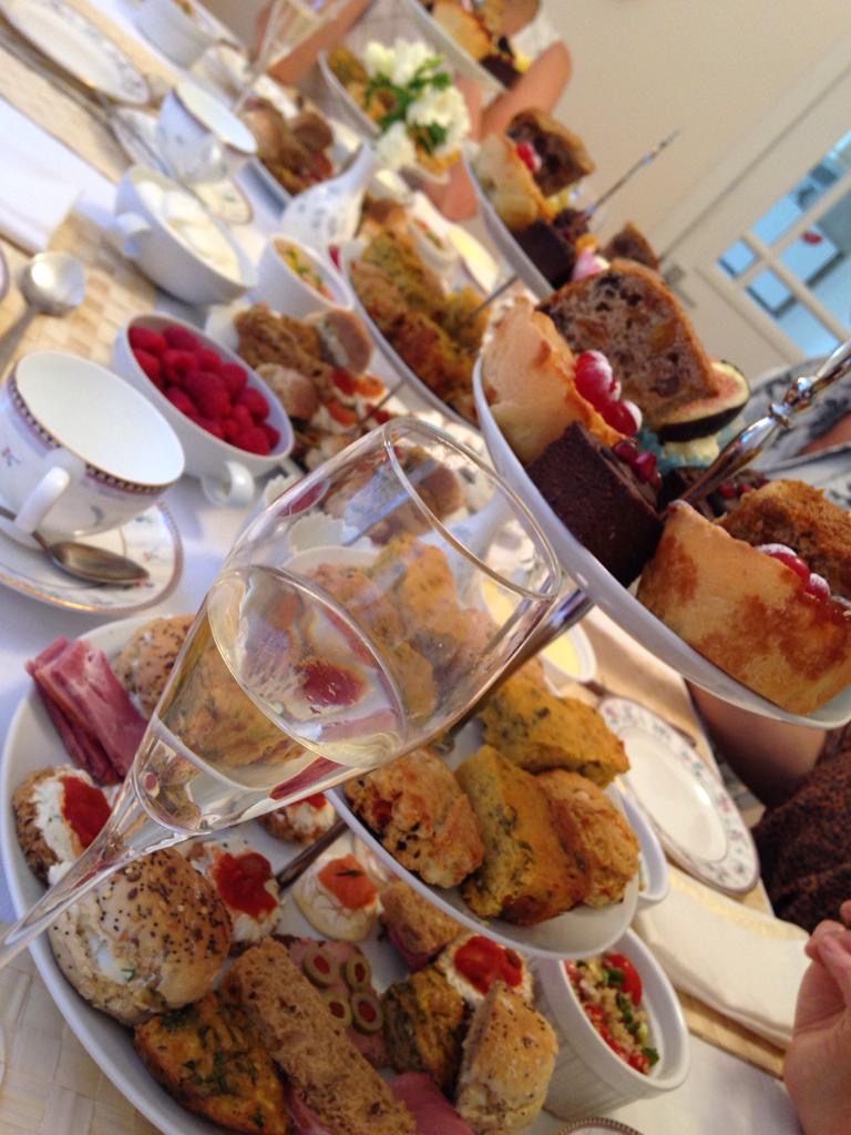 A table set with afternoon tea on three-tiered cake stands