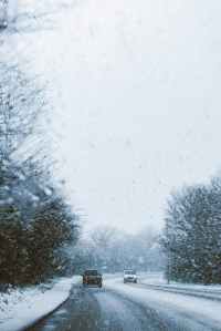 snowy road seen through a car windscreen