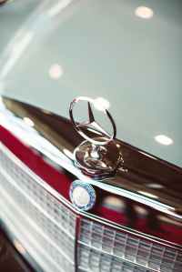 Close up of a Mercedes logo on a car bonnet