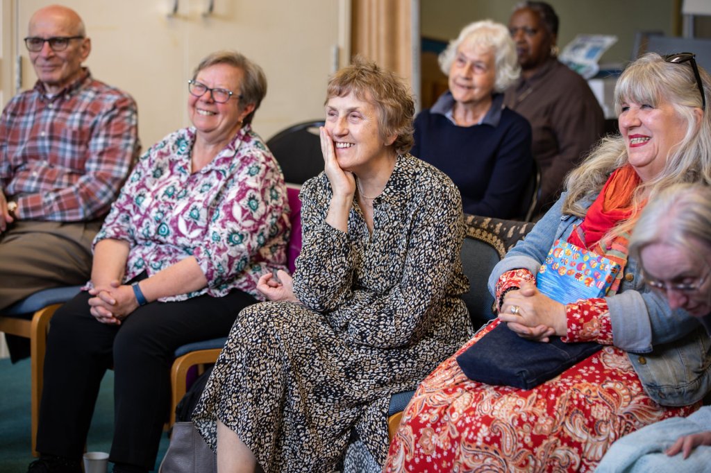 View of the audience of members and guests listening intently